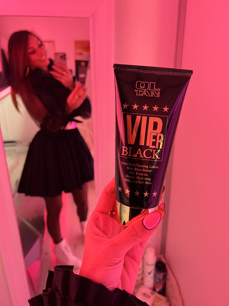 Customer Applying Ql Tan Lotion Before Opal Fitness Tanning Session In Peterborough