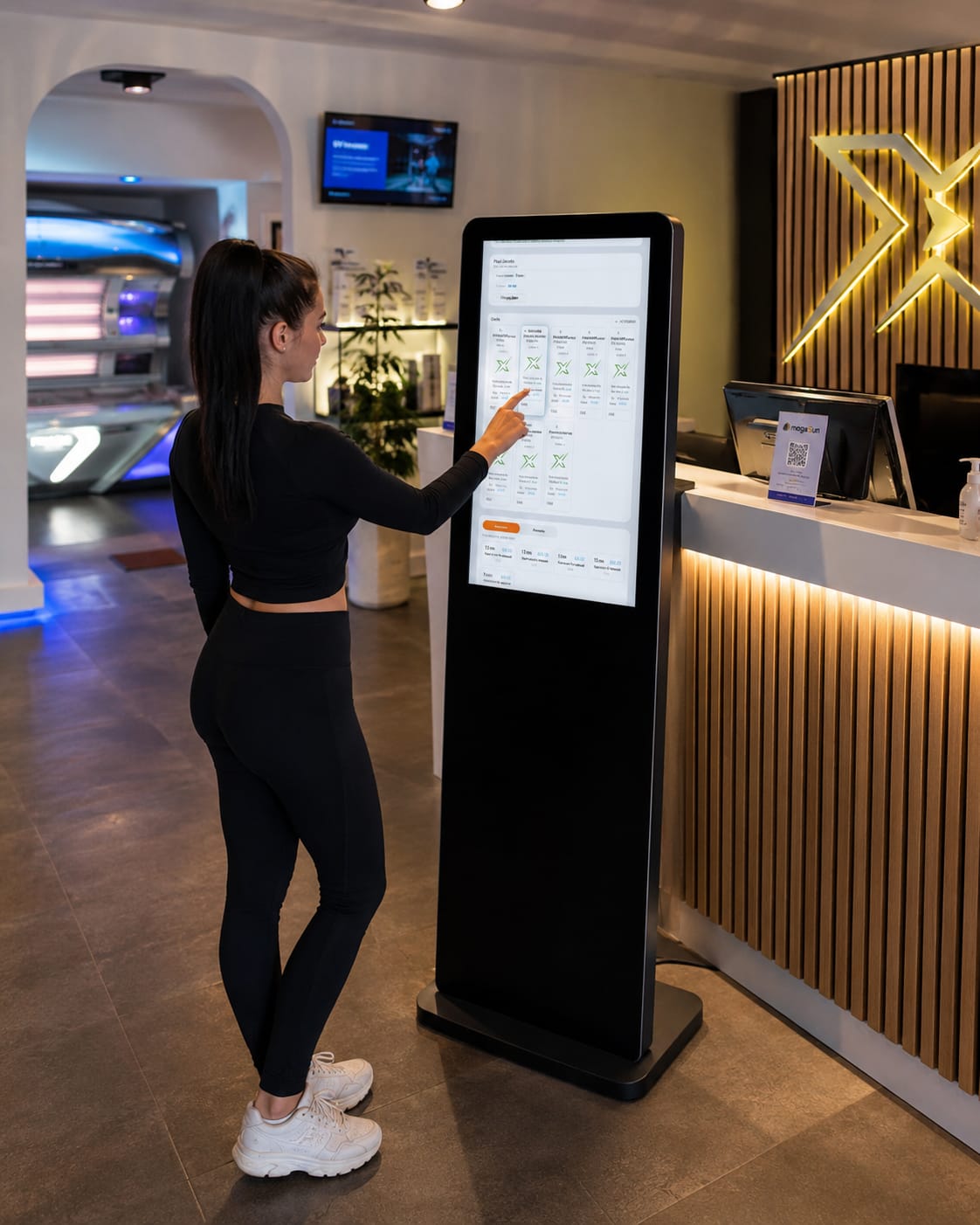Customer using XTan self-service kiosk in tanning salon